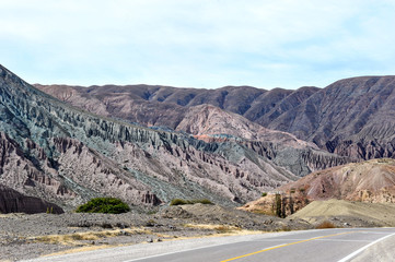 Coloured rock mountains. Hill of Seven Colors over Purmamarca village. Quebrada de Humahuaca valley, a UNESCO World Heritage Site, Argentina.