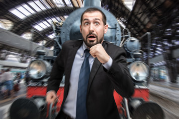 Businessman escaping from a vintage train