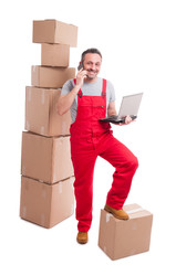 Full body of mover man holding laptop and talking at phone