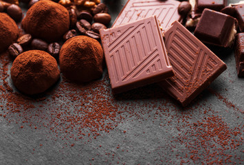 Variety of sweet homemade chocolate pralines on wooden background