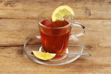 Lemon tea in a glass cup and saucer