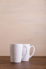 Mock-up mugs. Mockup coffee or tea cups. Design concept for branding. Front view. Wooden rustic board.