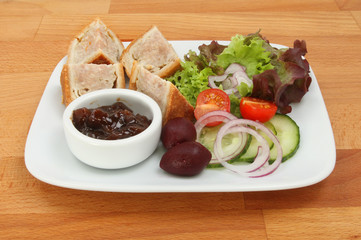 Pork pie and salad on a table