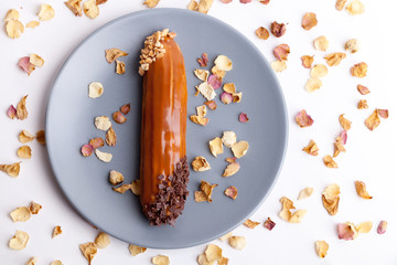 Group French dessert Eclair on a gray background plate.