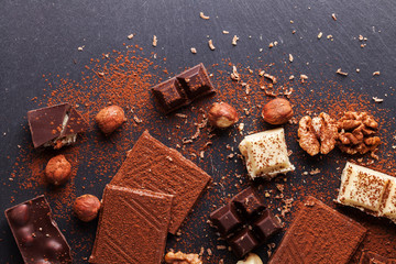 Variety of sweet homemade chocolate pralines on wooden background