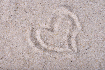 Heart drawn on sea sand, close up view
