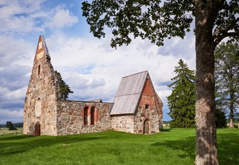 Fototapeta na wymiar Ancient roofless church ruins on a beautiful sunny mid-summer day in Finland.