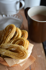 Churros accompanied of a cup of chocolate hot
