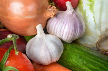 Two large garlic among other vegetables.