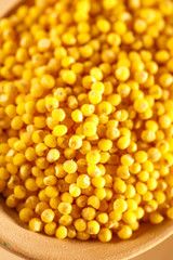 Millet groats with wooden spoon