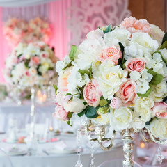 bouquets of roses and eustoma in restaurant interior.