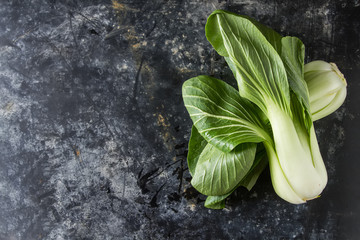 Overhead shot of Chinese cabbage, Bok Choy, on rustic background - obrazy, fototapety, plakaty