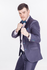 Naklejka premium portrait of angry business man fists in air on white background.