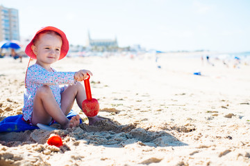 Girl playing with sand on the beach