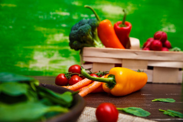 Fototapeta na wymiar Sweet pepper, brocoli and cherry tomatoes. Brocoli and red radish. Natural raw vegetables. Organic bio food on rustic wooden table.