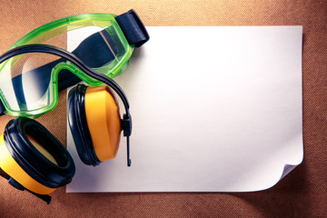 Earphones, goggles and blank paper