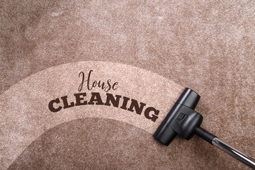 Vacuuming carpet with vacuum cleaner. House cleaning. Housework service. Close up of the head of a sweeper cleaning device.