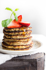Banana pancakes with strawberries and mint