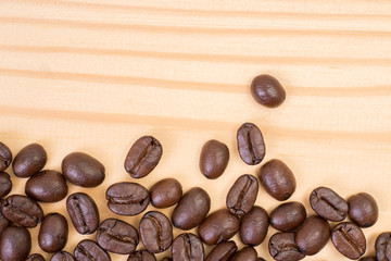 Top view of close up roasted coffee beans on wood texture background