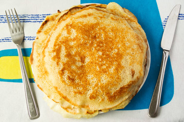 Fresh homemade pile of pancakes on a colorful background