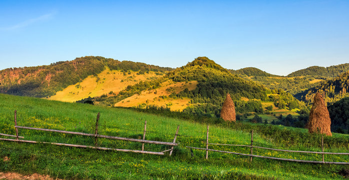 stacks of hay on the hill side