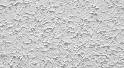 Texture of the plaster on the wall of the building. Background of white and gray painted figures.