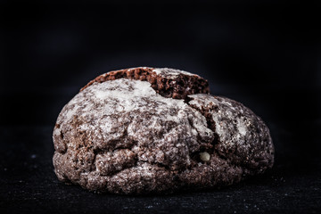 Homemade chocolate cookies, shortbread on a black slate table. Toned