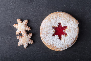 Homemade cookies with jam, shortbread on a black slate table