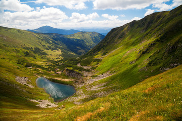 Beautiful highland lake Brebeneskul in the Ukrainian Carpathians. View from above. Ukrainian nature of the beautiful places of the country. Buffer zone. Summer sunny day. Nice view of the mountains.