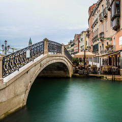 Fototapeta na wymiar long time exposure of a typical venetian bridge over a canal, Venice, Italy, Europe