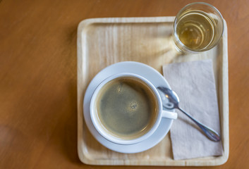 Cup of coffee on wooden tray