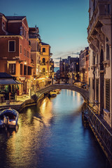 Fototapeta na wymiar Typical small Venetian Canal in the evening, Venice (Venezia), Italy, Europe, Vintage filtered style