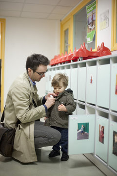 Father dropping toddler son off at preschool
