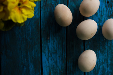 White eggs on blue wooden background. Easter spring time.