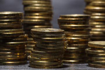 Stacks of gold coins on black background