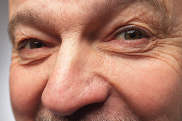 Man with mustache looking at the camera winking