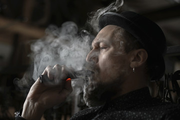 Man portrait smoking an electronic cigarette