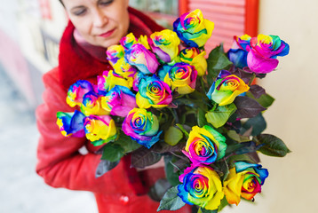 A bouquet of multicolored roses in hands