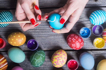 Woman painting easter eggs