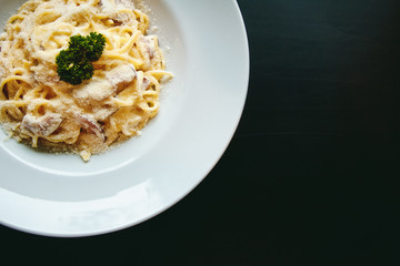 Classic Pasta carbonara Italian with Parmesan Cheese on black background