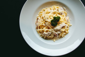Classic Pasta carbonara Italian with Parmesan Cheese on black background