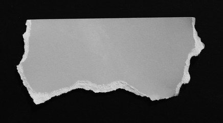 Ripped paper on black, space for advertising copy