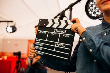 Clapper for movie chalk board in the hands of the girl