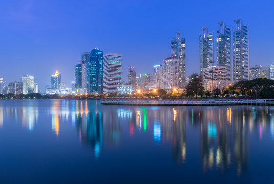 Bangkok city skyline at Benjakitti Park at night.