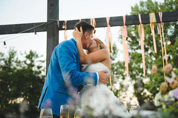 Kissing Newlyweds at Table