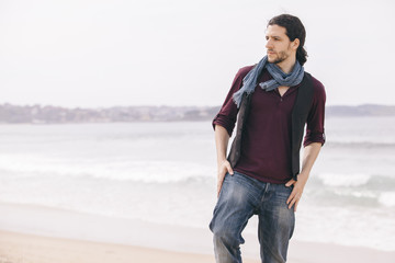 caucasian hipster man standing alone isolated on the beach