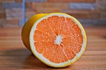 Yellow grapefruits on a wooden table