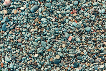 Wet pebbles on the beach.
