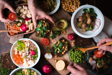 Eating different salad and appetizer on the wooden table top view
