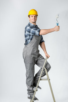Workman with paint roller